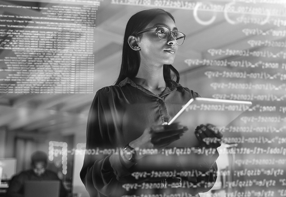 Developer analyzing a transparent wall of code holding a tablet